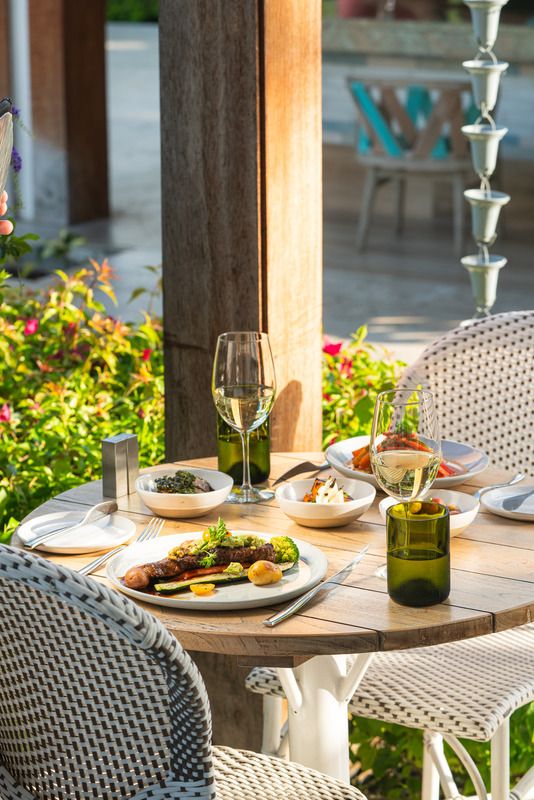 white wine and food on the beach in barbados