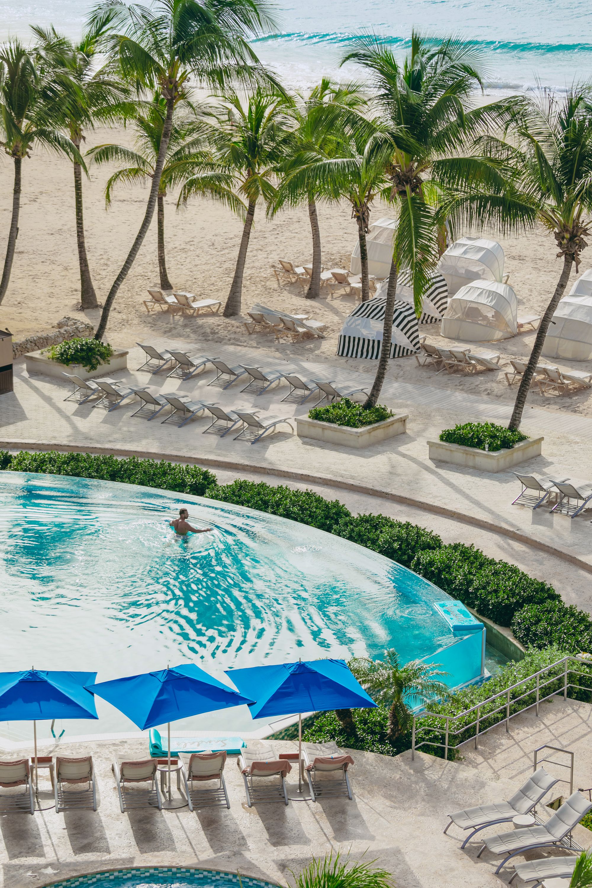 man in infinity pool at sandals barbados