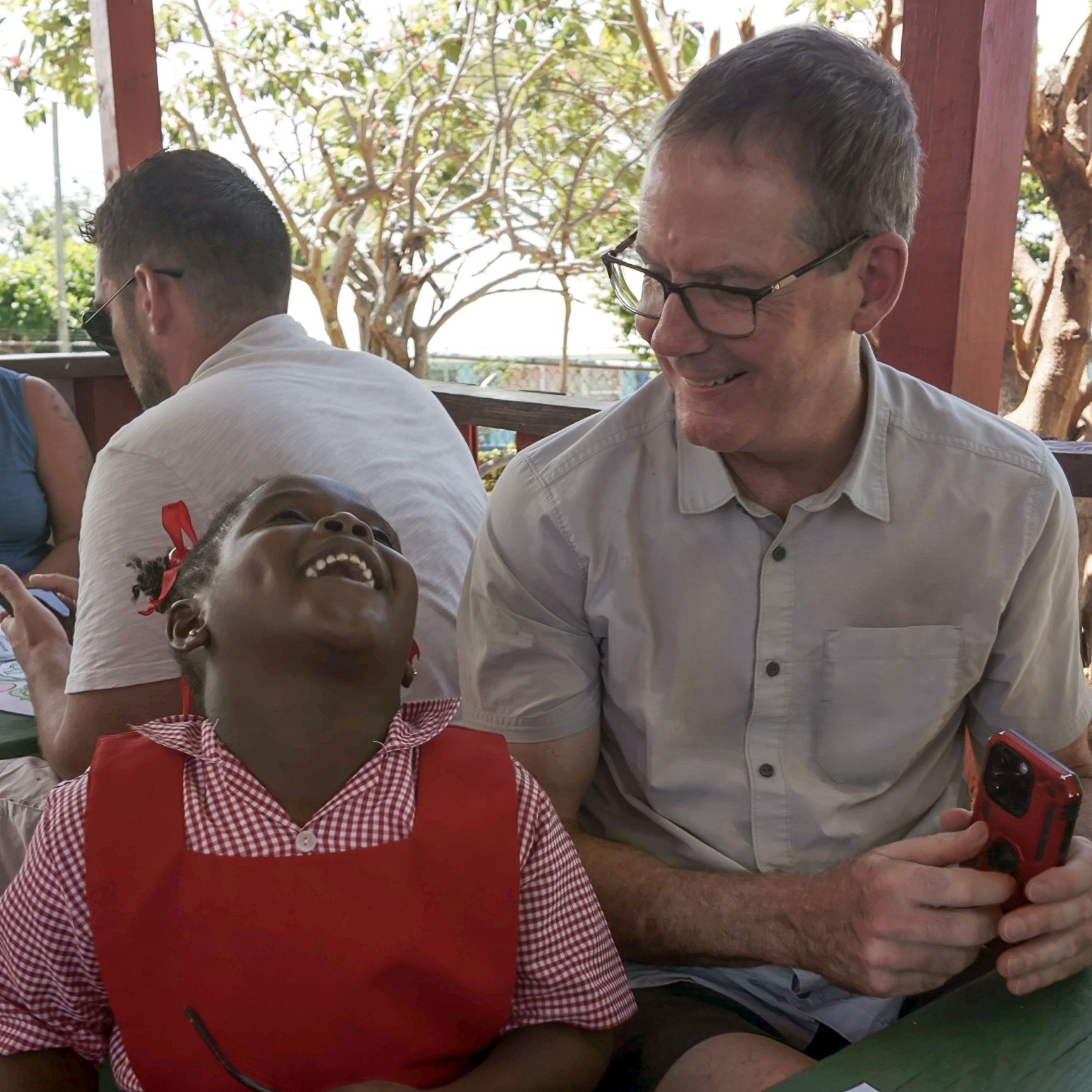 man and child sitting down laughing