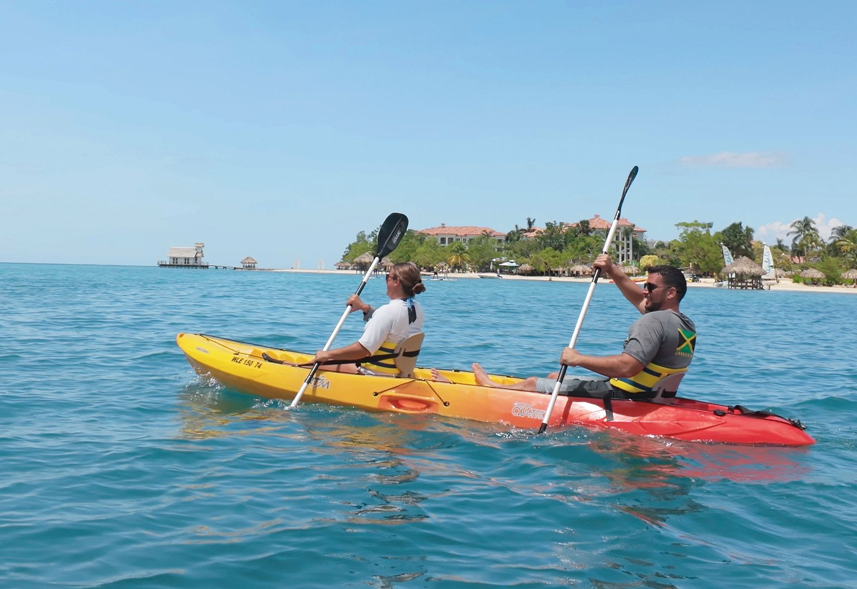 man and woman kayaking at sandals south coast resorts