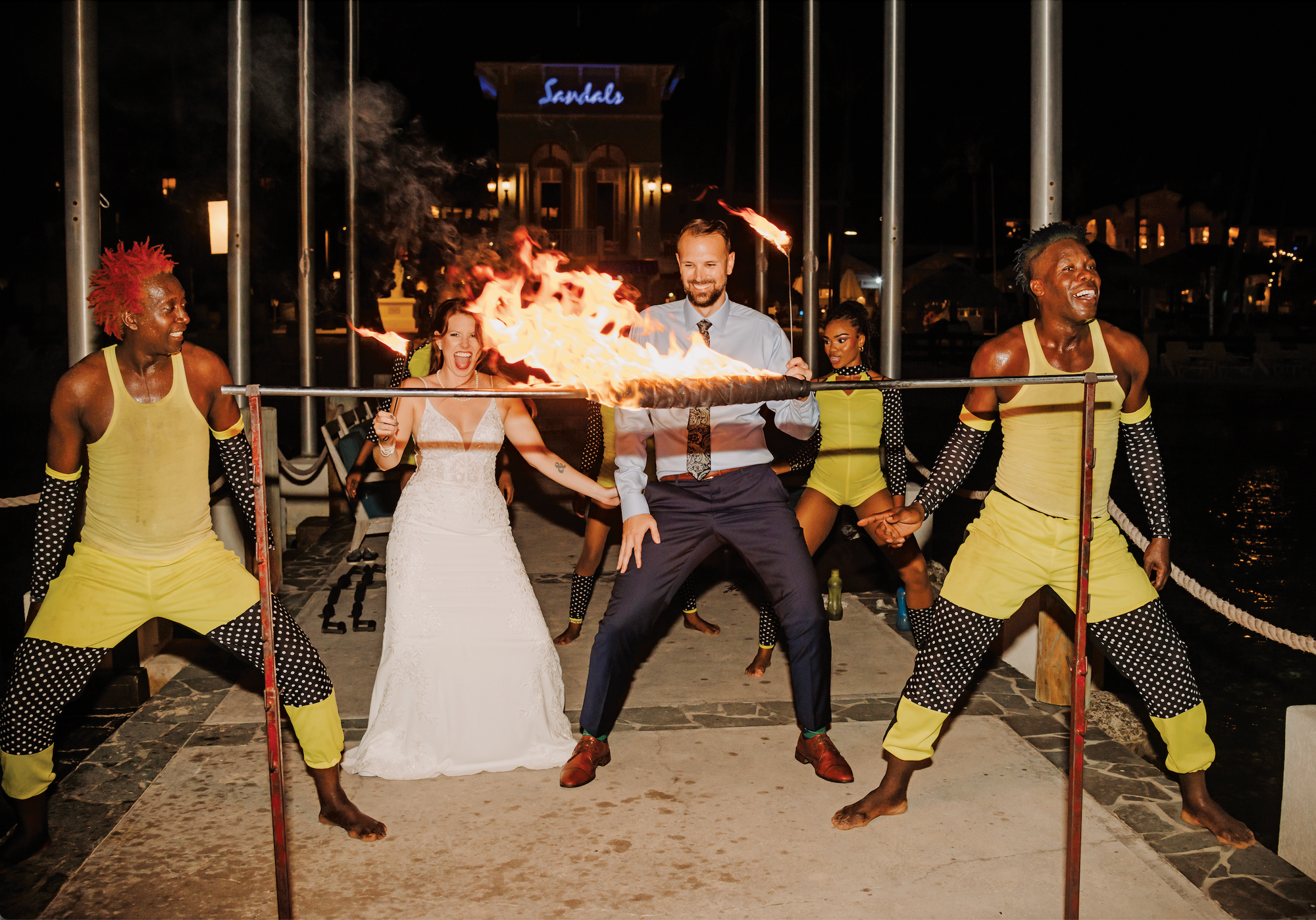 couple playing the limbo at sandals resorts