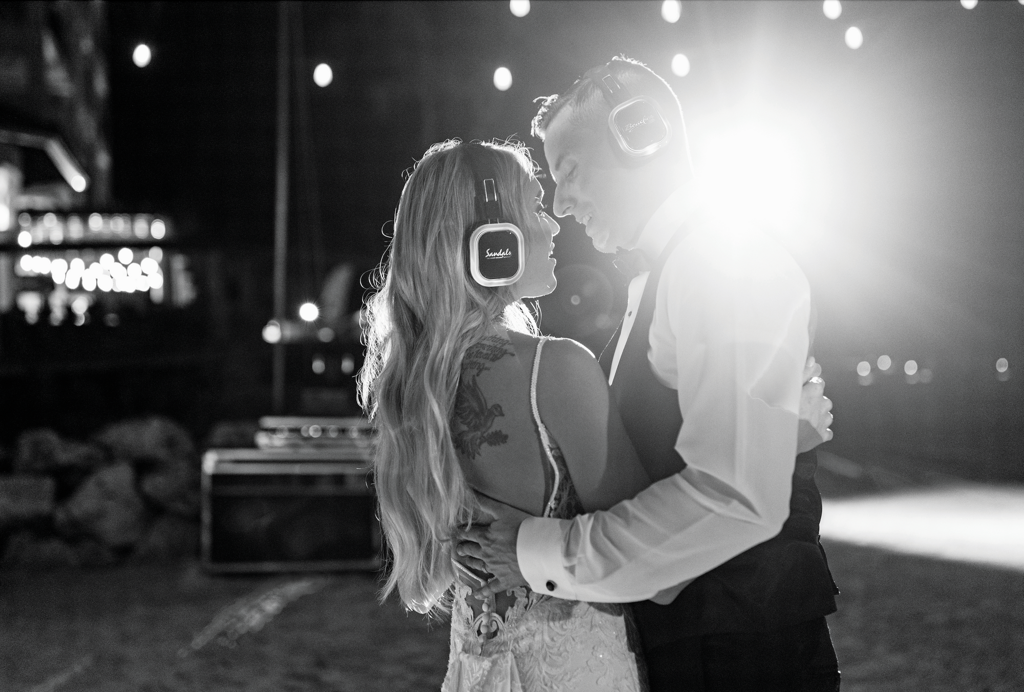 bride and groom dancing at a silent disco with headphones on