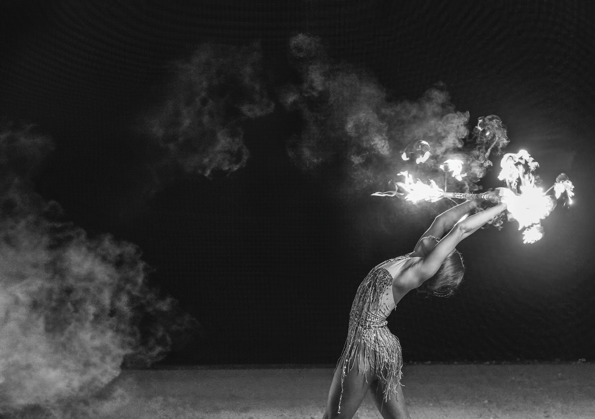 a fire dancer on the beach