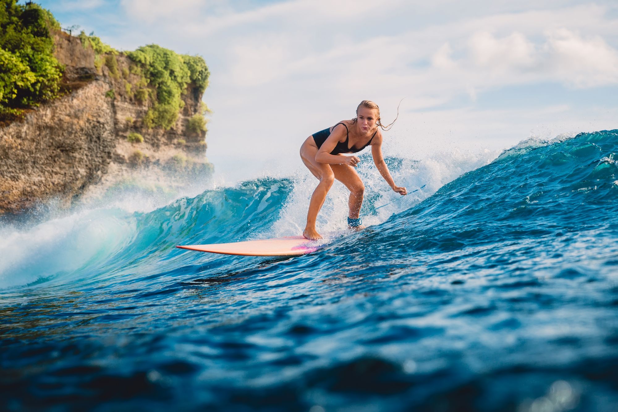 Woman in bikini surfing