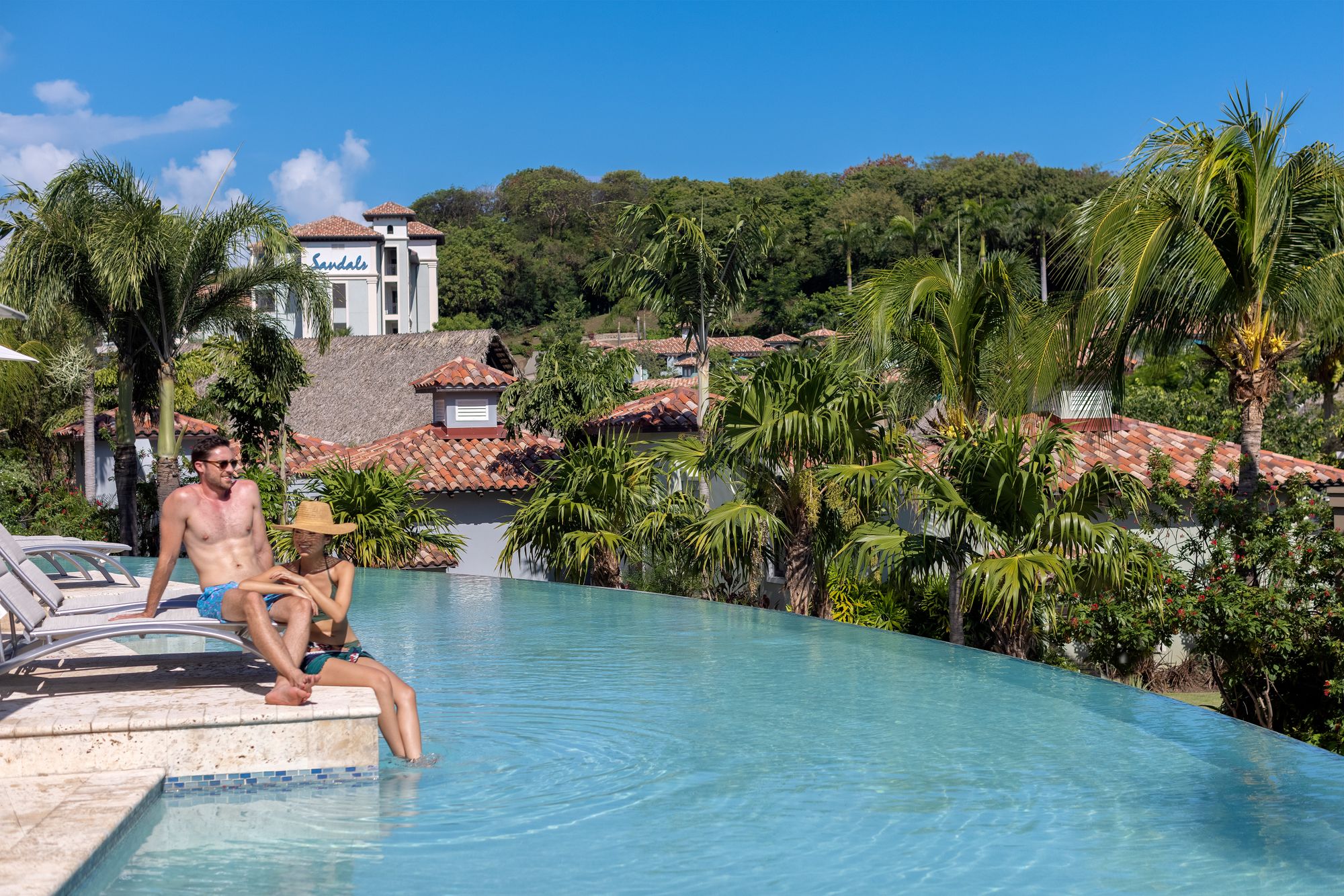 Couple sitting by pool