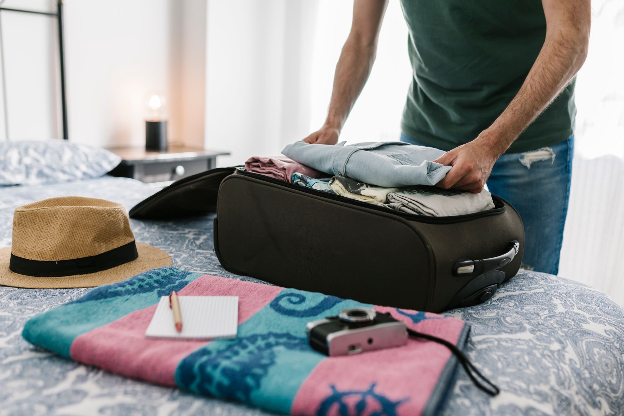 man packing suitcase