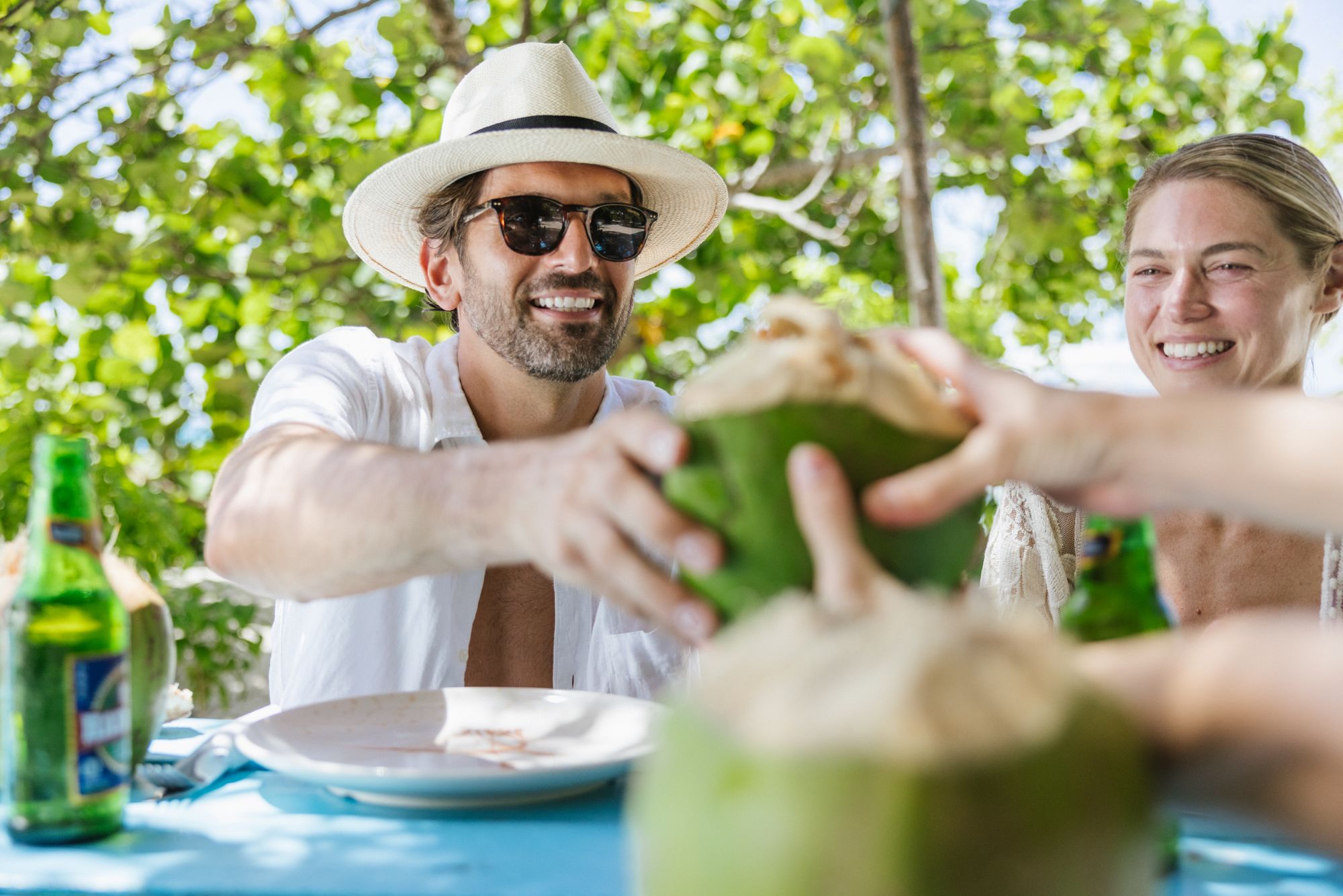  ouple in Caribbean drinking coconuts