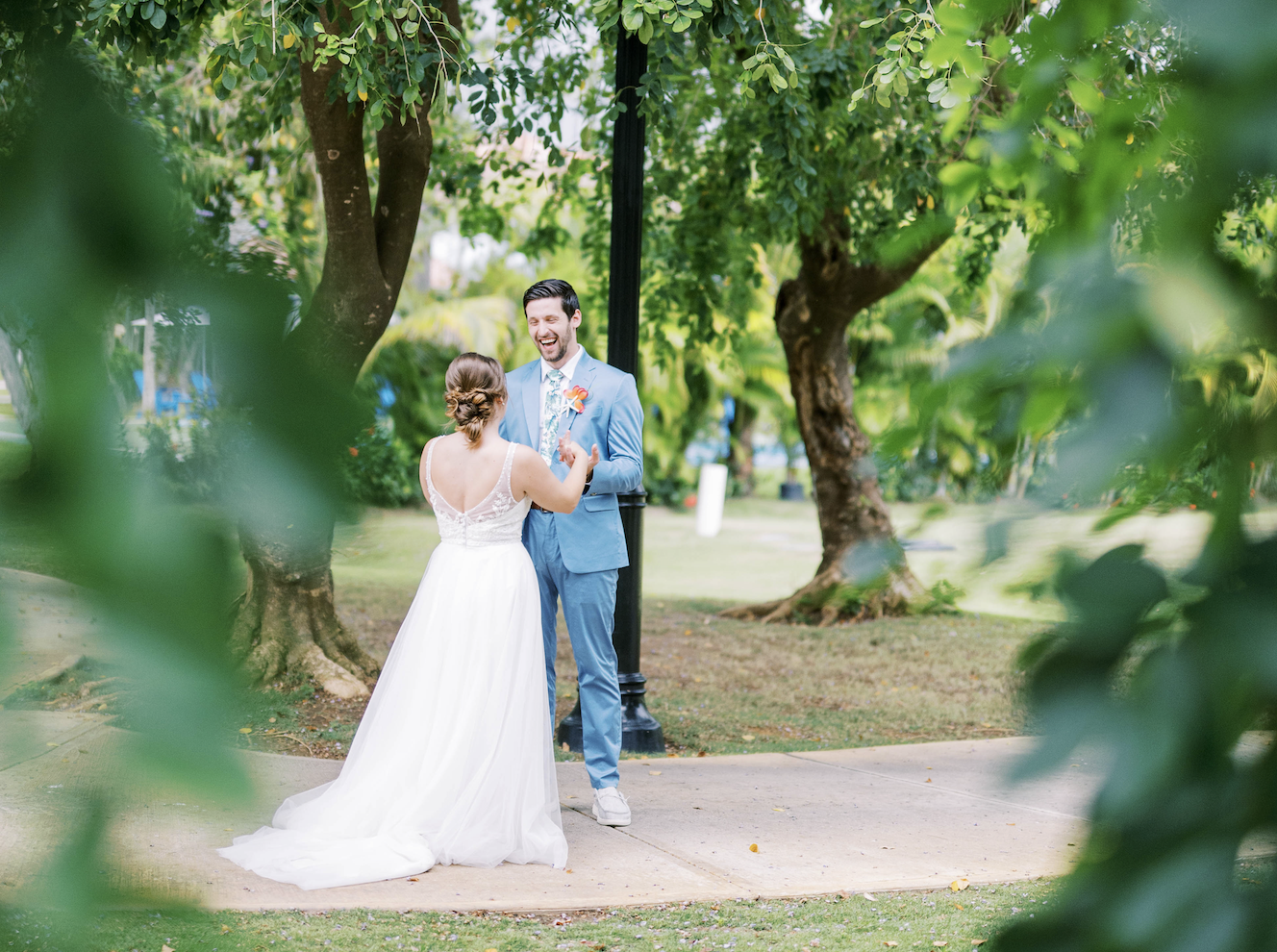 bride-groom-facing-each-other-near-lush-landscape