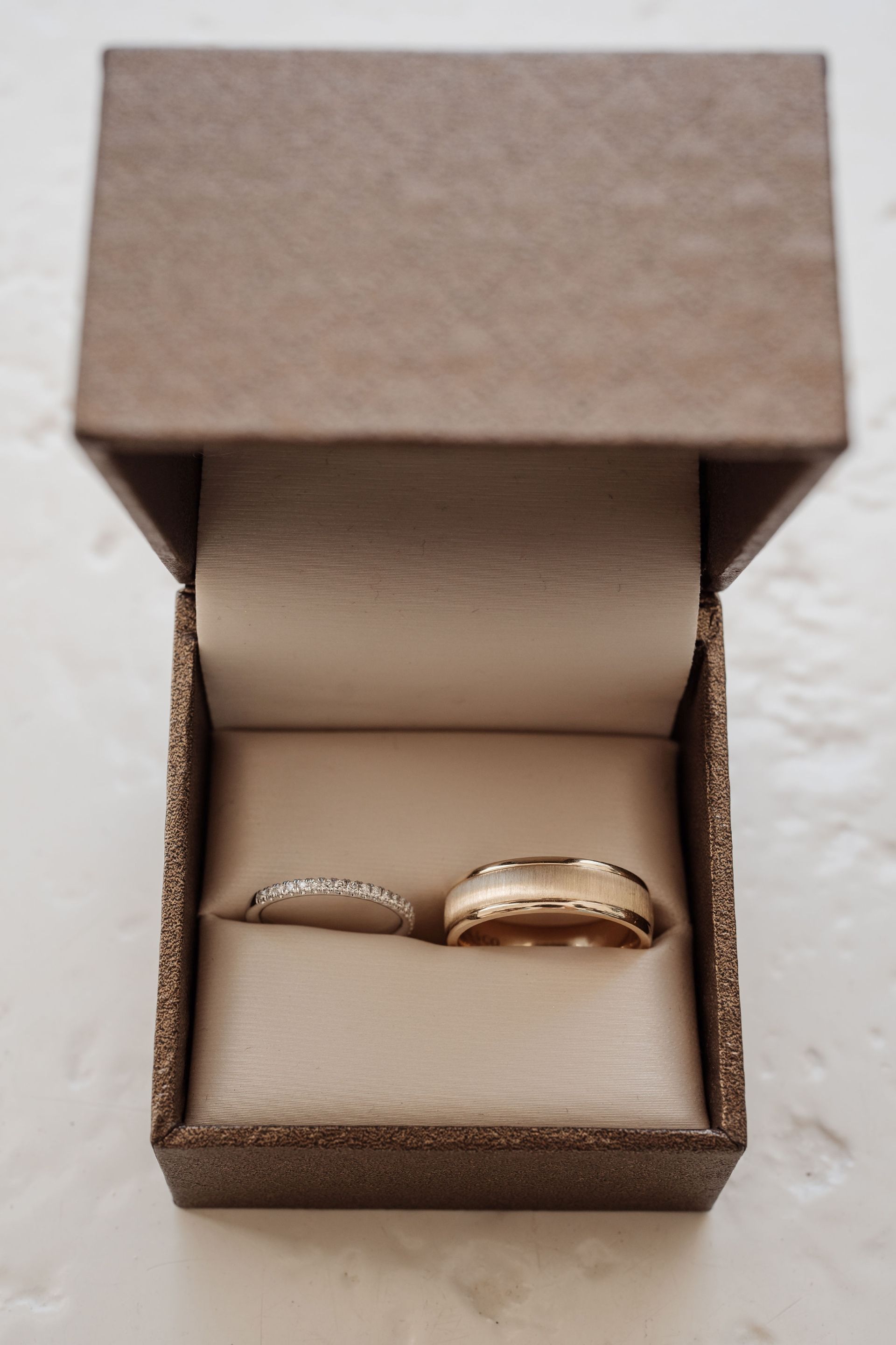 Wedding bands displayed in an open ring box for travel planning